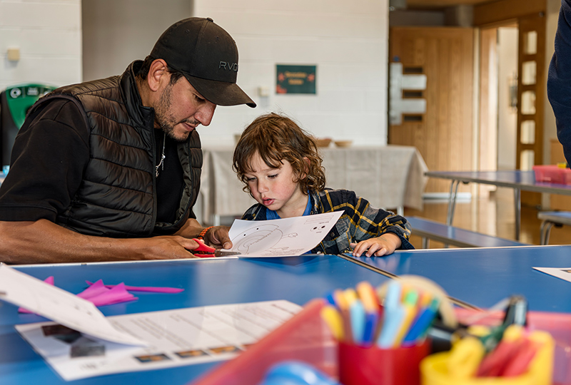 A photo of a man and a child taking part in Make and Take.