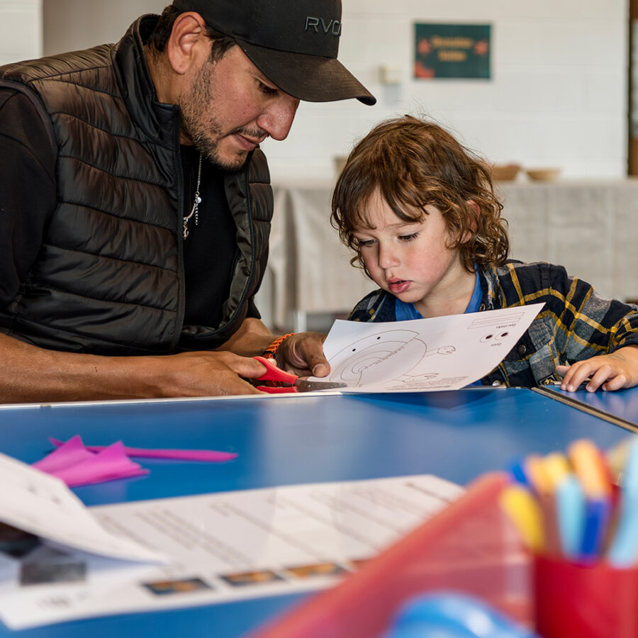 A photo of a man and a child taking part in Make and Take.