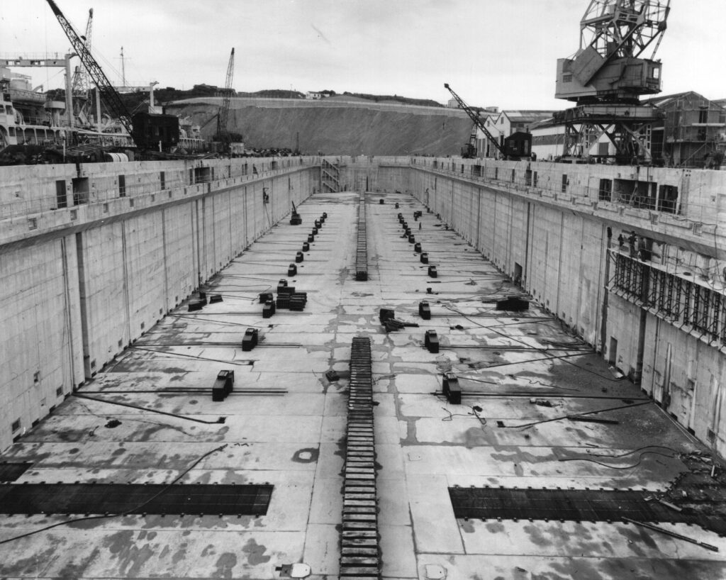 A black and white photograph of a dock showing the keel blocks and traversing bilge blocks.