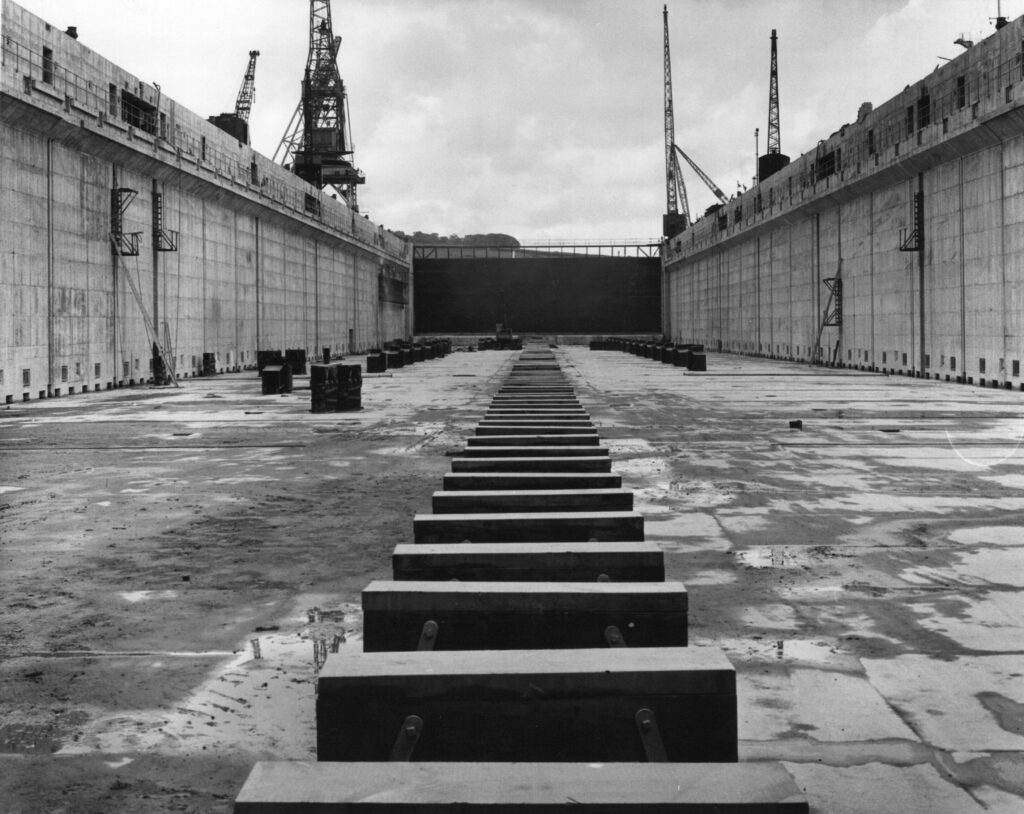 A black and white photograph of a dock showing the keel blocks and traversing bilge blocks.