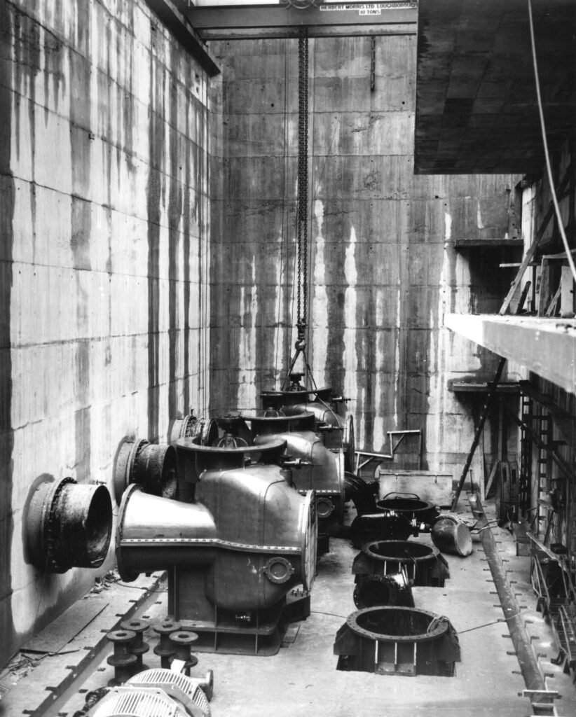 A black and white photograph of three 48-inch diameter, 650 horse-power electric pumps.