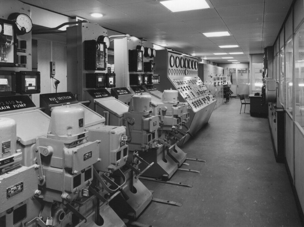 A black and white photograph of the dock control room in 1958. 