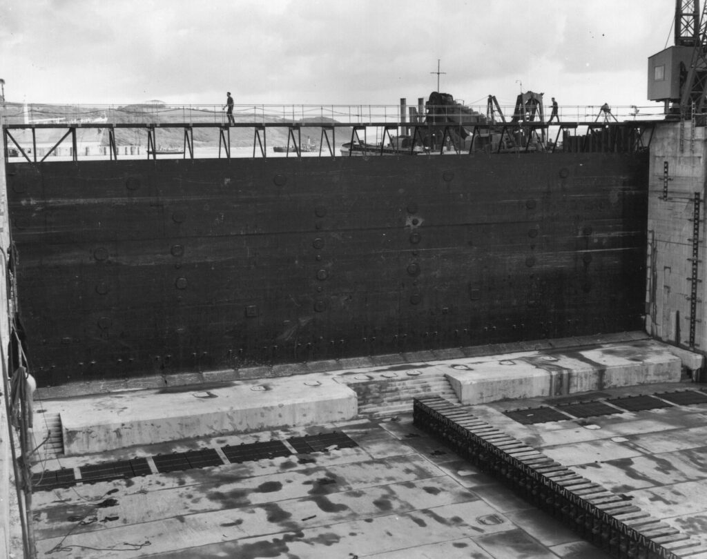 A black and white photograph showing the dock gate and keel blocks.