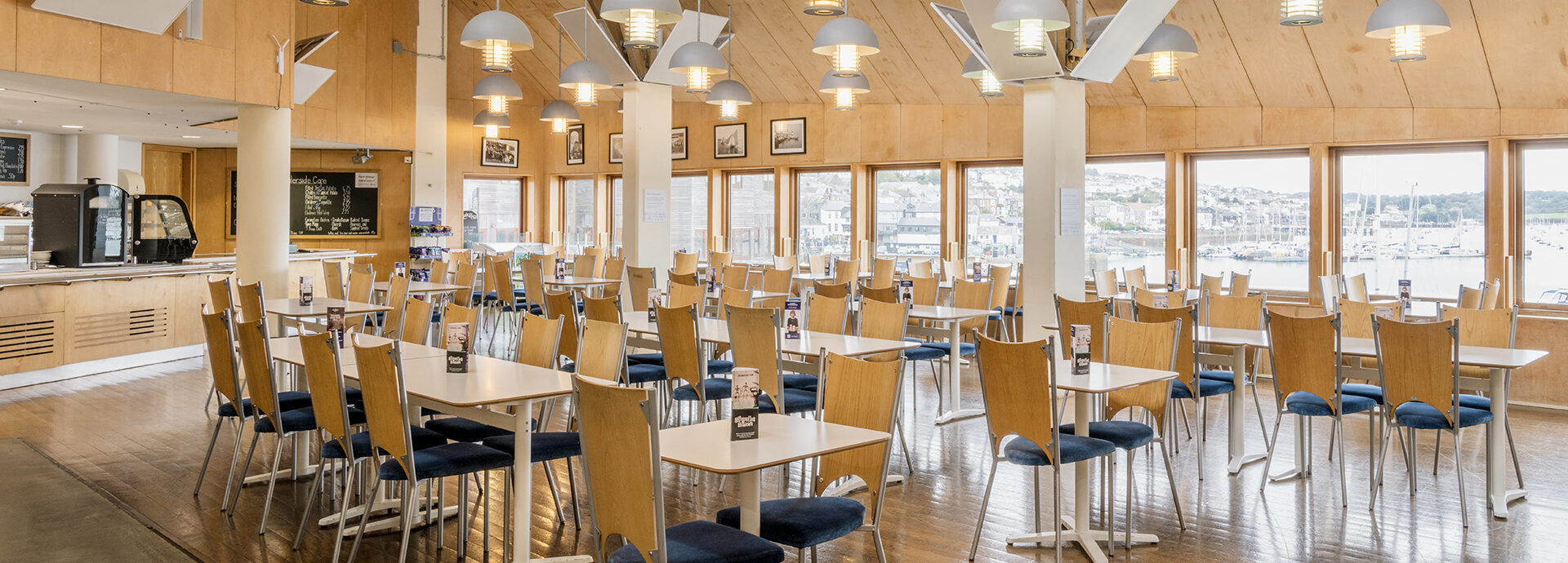 A photograph of the cafe space at the National Maritime Museum, with tables and chairs.