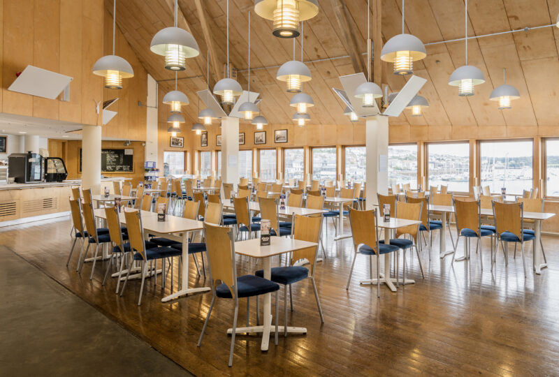 A photograph of the cafe space at the National Maritime Museum, with tables and chairs.