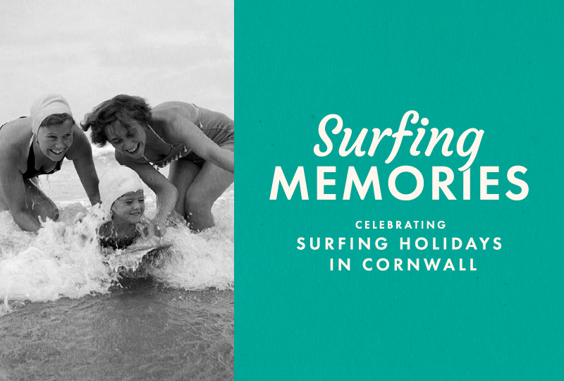 Two women and one child, in vintage swimsuits laugh and play in the surf at the beach; text reads "Surfing Memories, Celebrating Surfing Holidays in Cornwall."