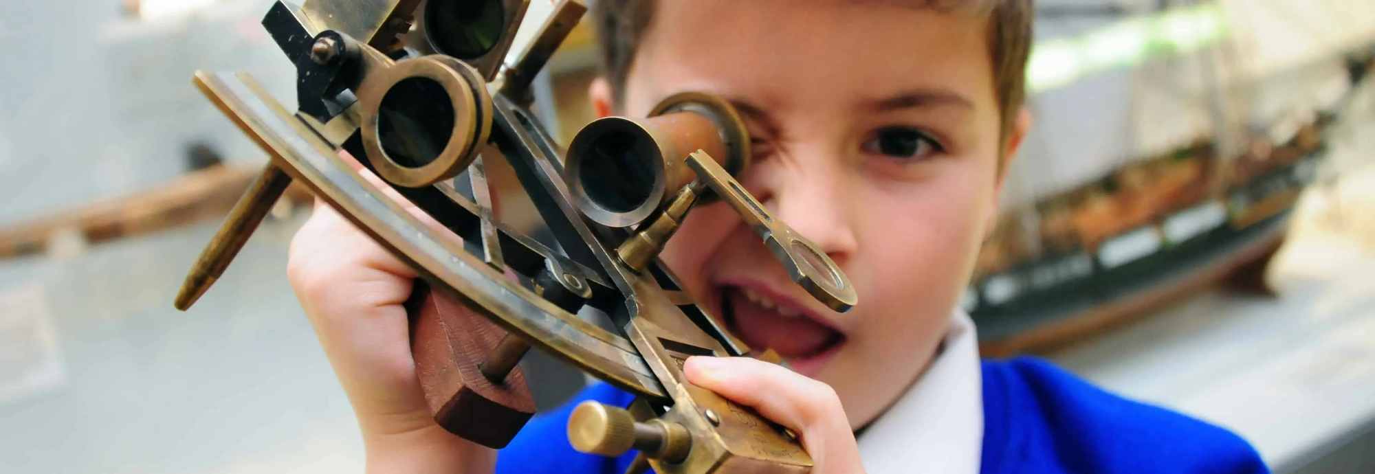 A school boy uses navigation equipment in a school workshop at National Maritime Museum Cornwall