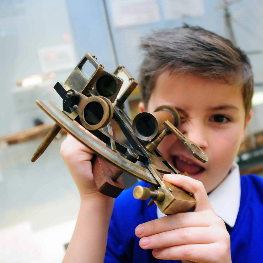 A school boy uses navigation equipment in a school workshop at National Maritime Museum Cornwall