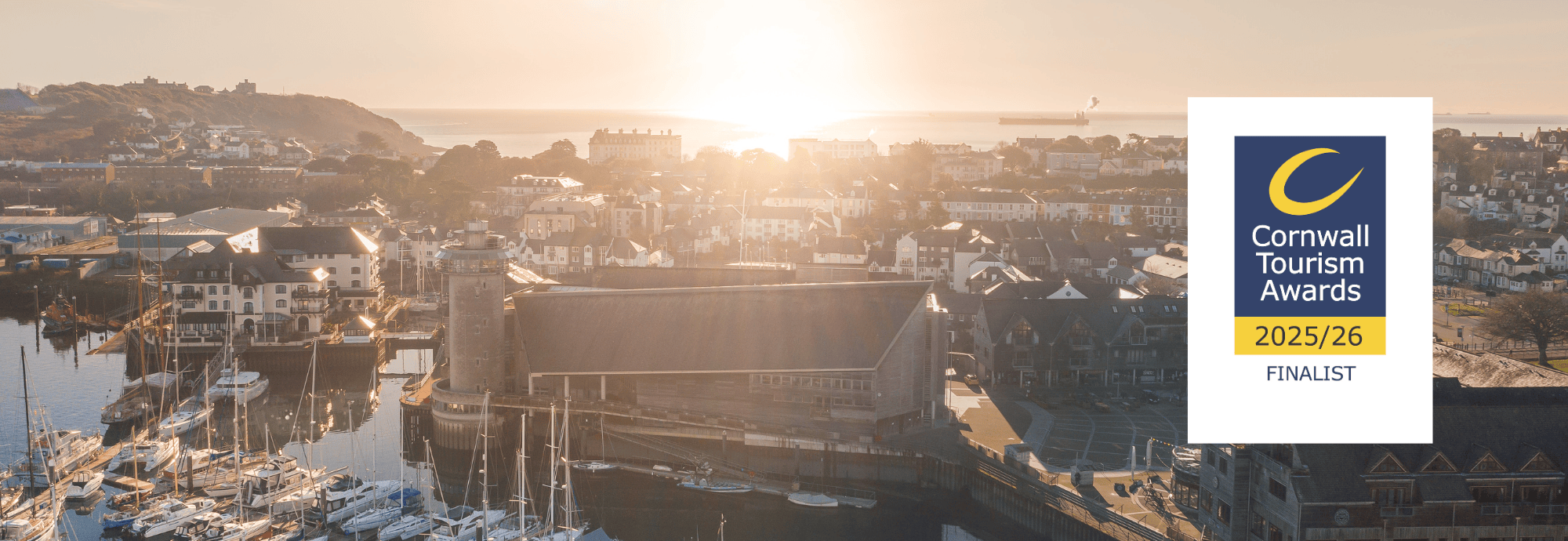 An aerial photograph of National Maritime Museum Cornwall with a graphic logo that reads Cornwall Tourism Awards 2025/26 Finalist.