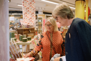 Two customers looking at items displayed in the Museum's gift shop.