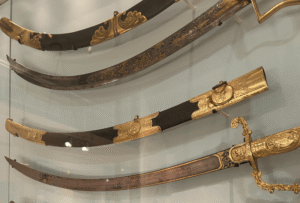 Wall-mounted Sailing Masters Presentation Swords in a display case at National Maritime Museum Cornwall.