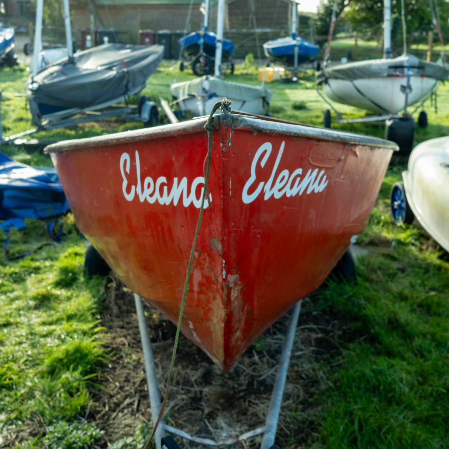 A small red boat with the name 'Eleana' painted on in white.