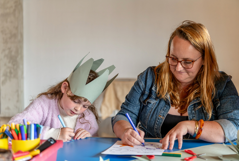 A family take part in craft colouring-in activities at National Maritime Museum Cornwall.