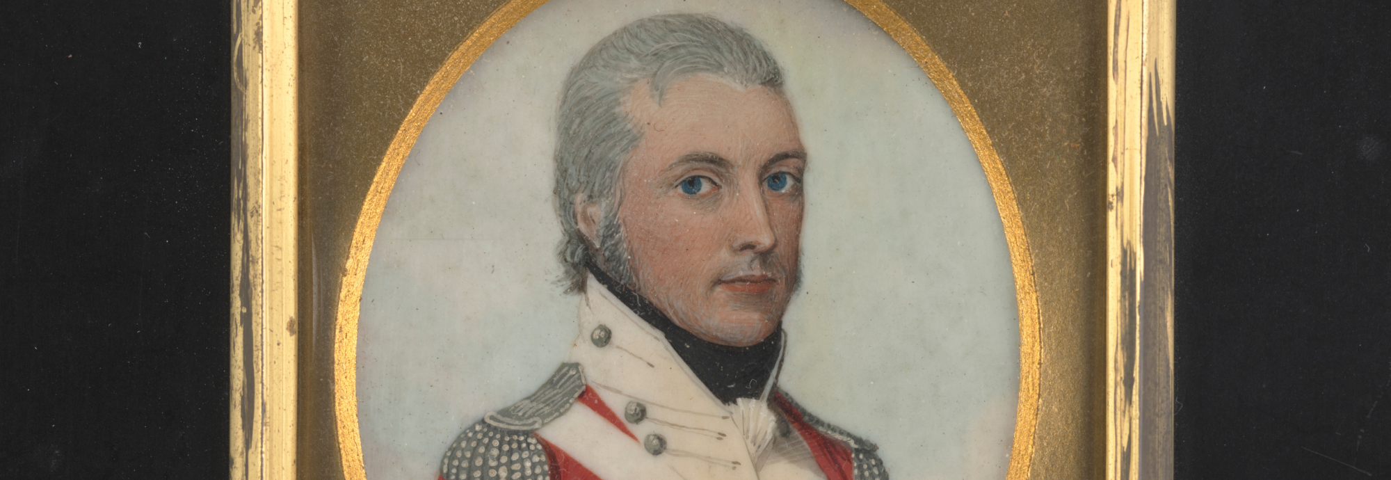 Portrait of a man with smart grey hair, wearing a military coat covered in buttons, with shoulder epaulettes.